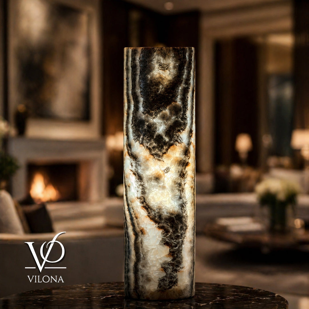 Stone onyx table lamp base with dark and light swirling pattern, cylindrical form.