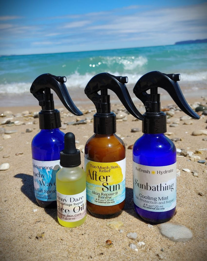 After sun spray set of three bottles with black mist nozzles, blue and amber liquids.
