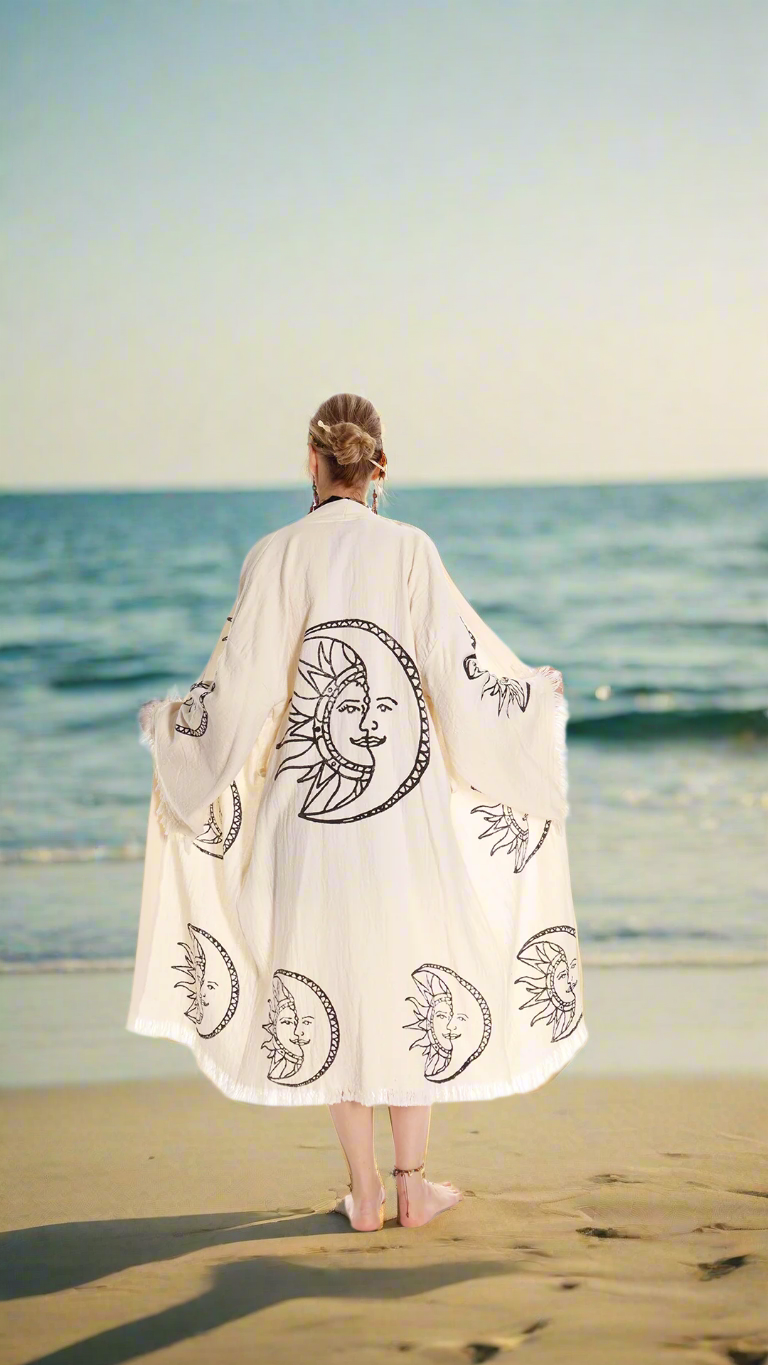 Beige organic cotton kimono robe, back view, moon-and-sun face print, fringe sleeves