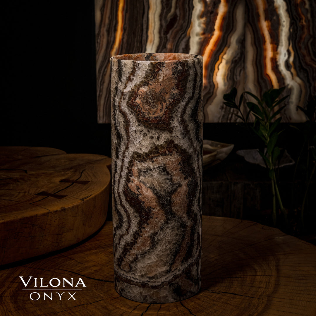 Dark onyx table lamp cylinder with amber glow lines and textured wavy stone pattern