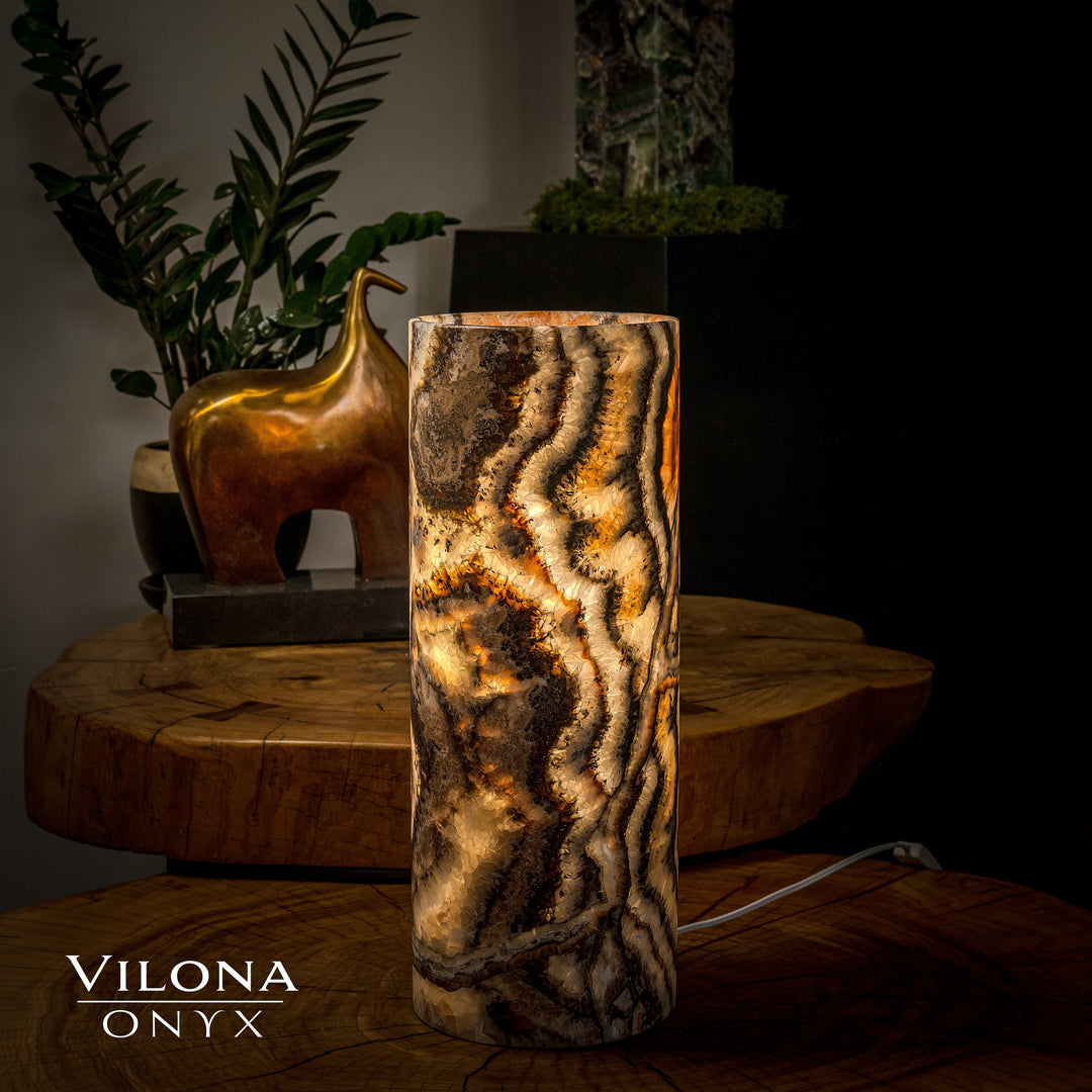 Dark onyx table lamp cylinder with glowing amber streaks and swirling vertical pattern