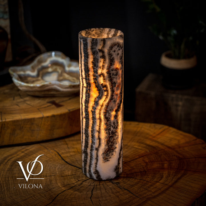 Onyx table lamp with amber-lit crystal column, black and white veining