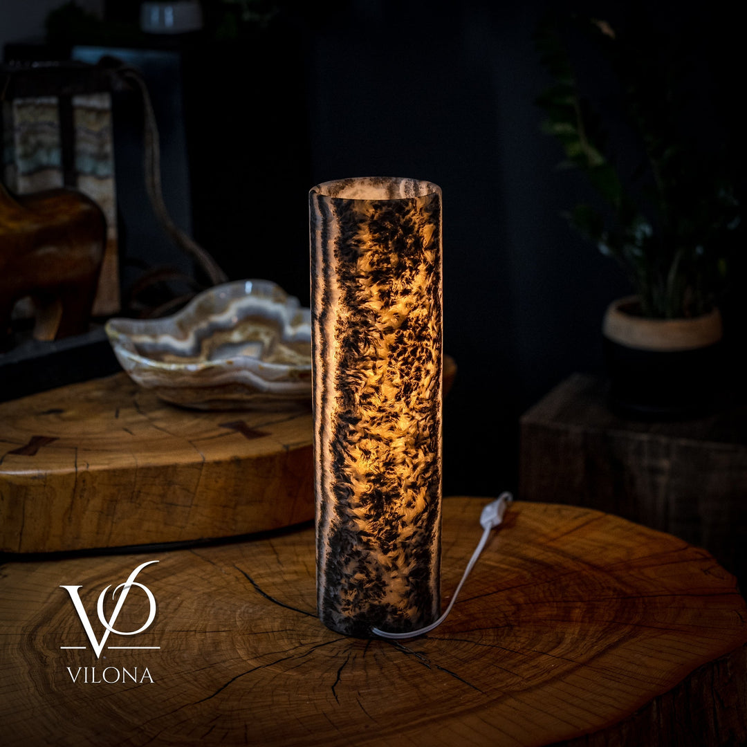 Onyx table lamp with amber-lit crystal column, textured mineral pattern