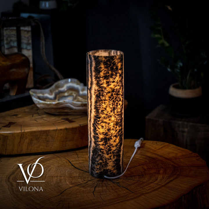 Onyx table lamp with amber-lit crystal column, textured mineral pattern