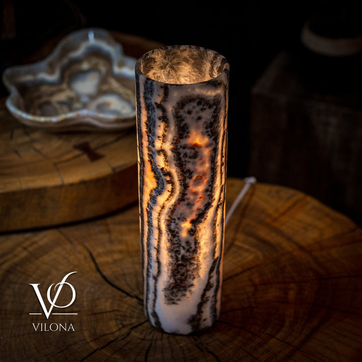 Onyx table lamp with amber-lit crystal column, arched top, dark curved veining