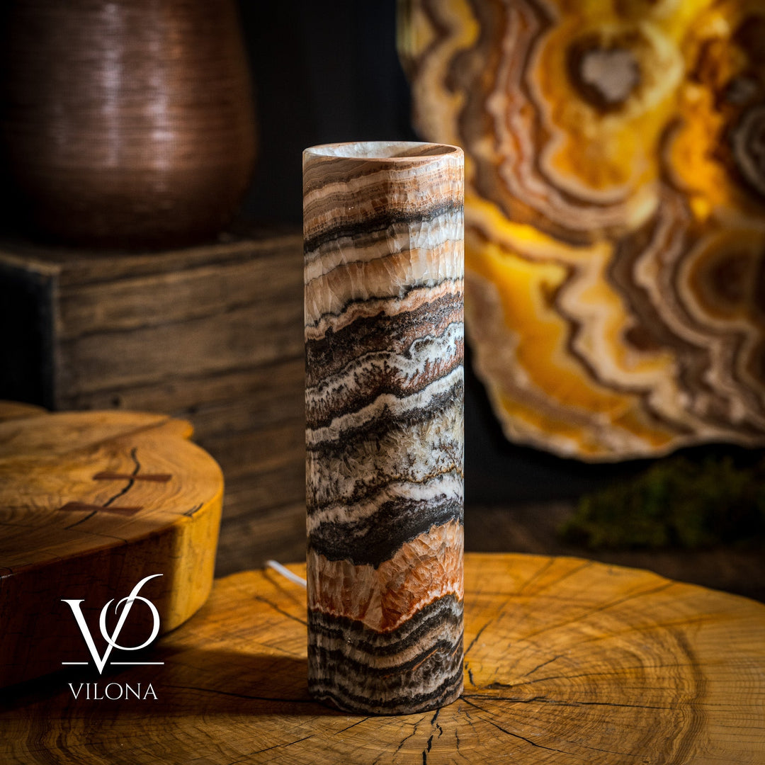 Onyx-striped column table lamp with white-to-brown swirls, top-lit cylinder shade