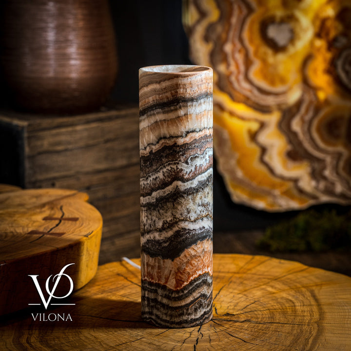 Onyx-striped column table lamp with white-to-brown swirls, top-lit cylinder shade