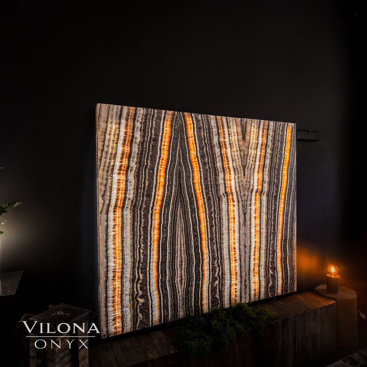 Striped onyx wall panel with orange, black, and cream vertical lines