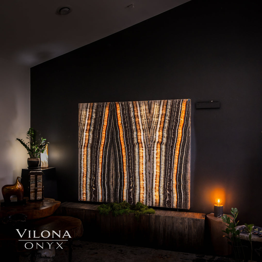 Amber and cream striped onyx wall panels mounted on a dark wall