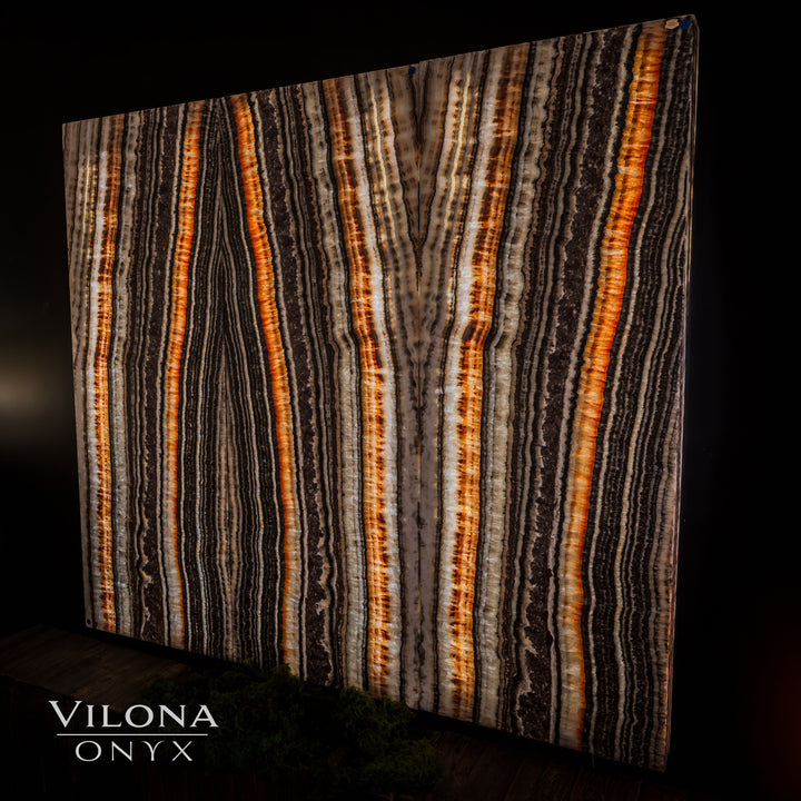 Onyx wall panel with vertical amber and cream stripes with deep dark streaks