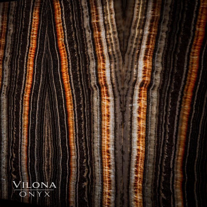 Detail view of onyx wall panel showing vertical orange-amber and cream bands