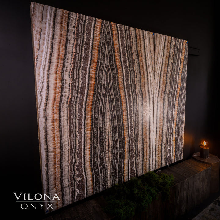 Striped onyx wall panel with mauve, gray, and cream vertical lines