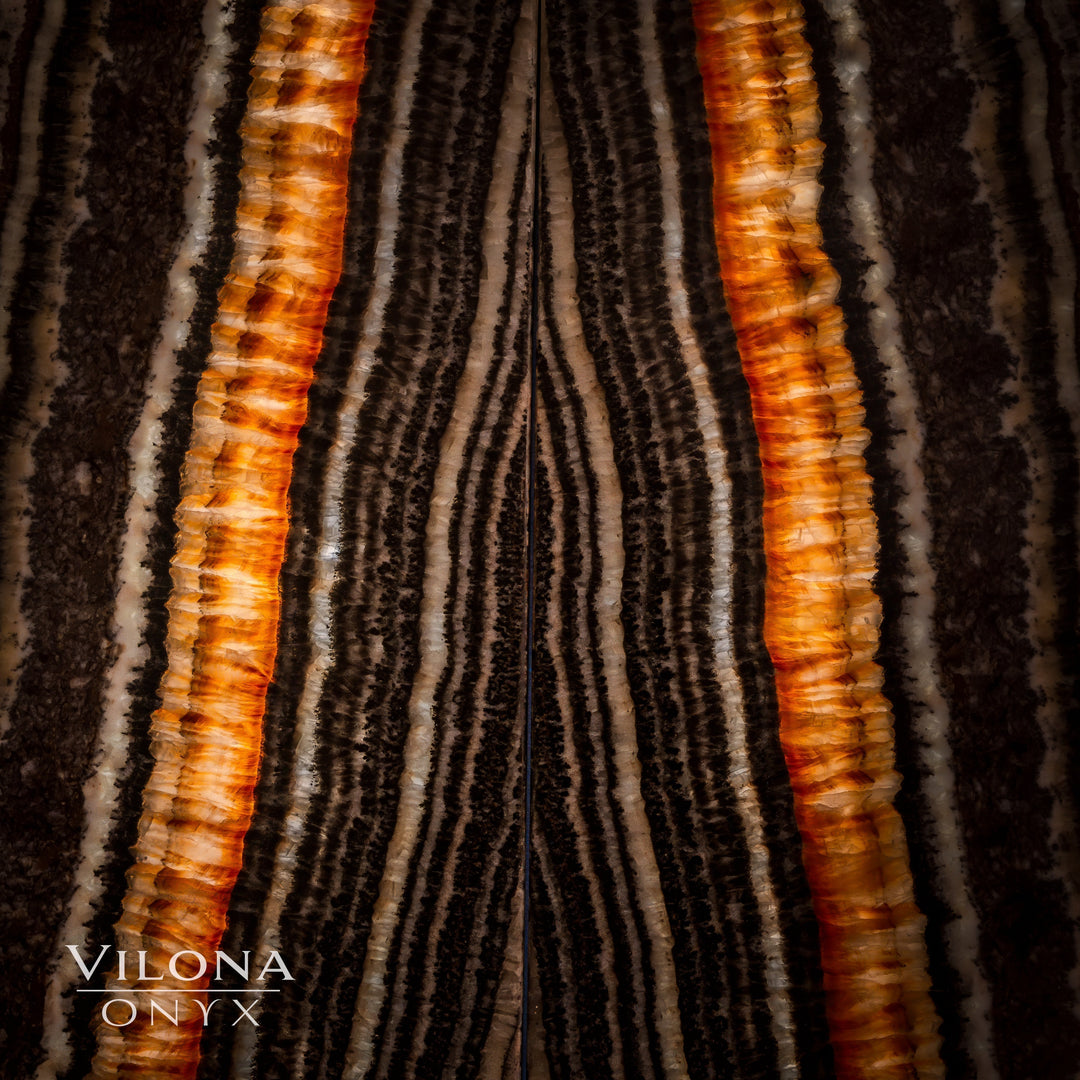 Onyx wall panel close-up with bold vertical amber stripes and dark charcoal grooves