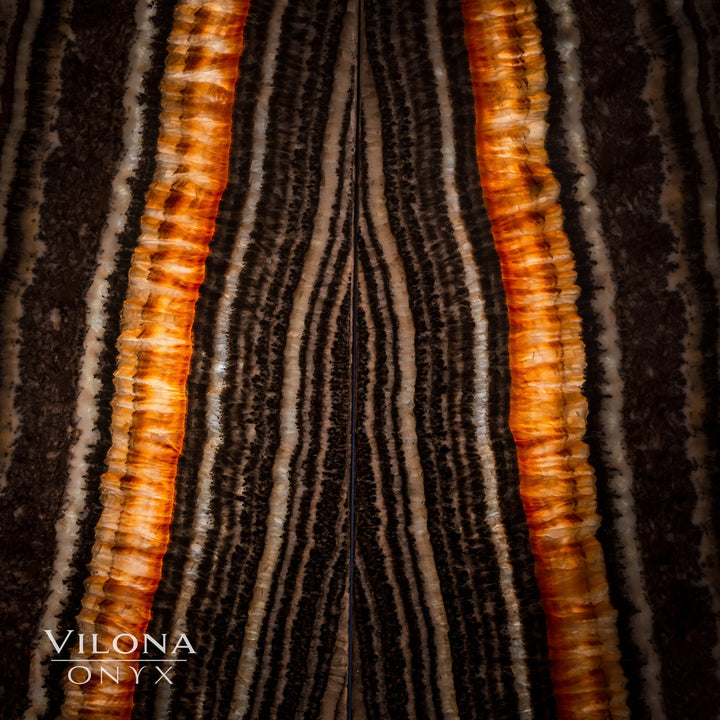Onyx wall panel close-up with bold vertical amber stripes and dark charcoal grooves