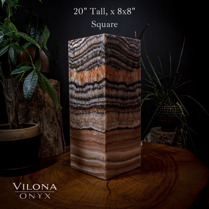 Medium square table lamp with tall striped onyx shade, warm orange glow