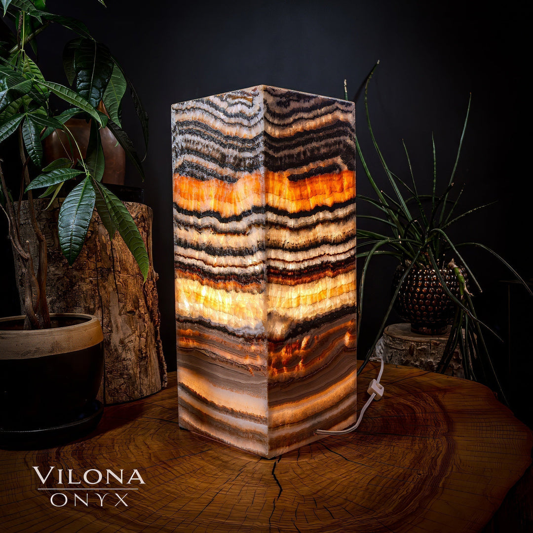 Medium square table lamp, front view of striped onyx shade with bright orange bands