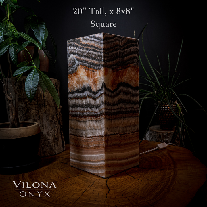 Square table lamp featuring layered onyx stripes with warm amber and dark brown tones