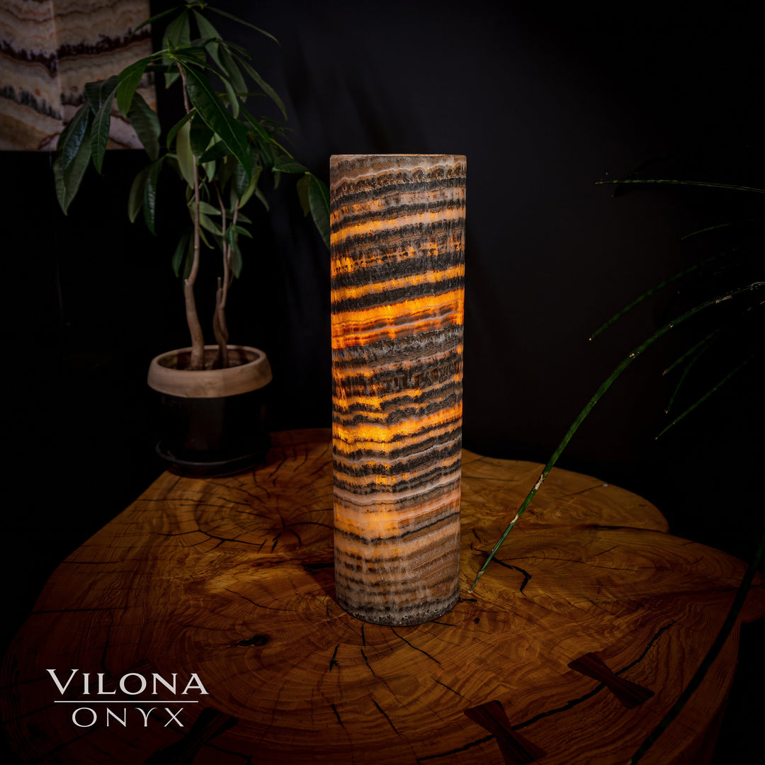 Table lamp with cylindrical onyx shade, amber and dark striped pattern