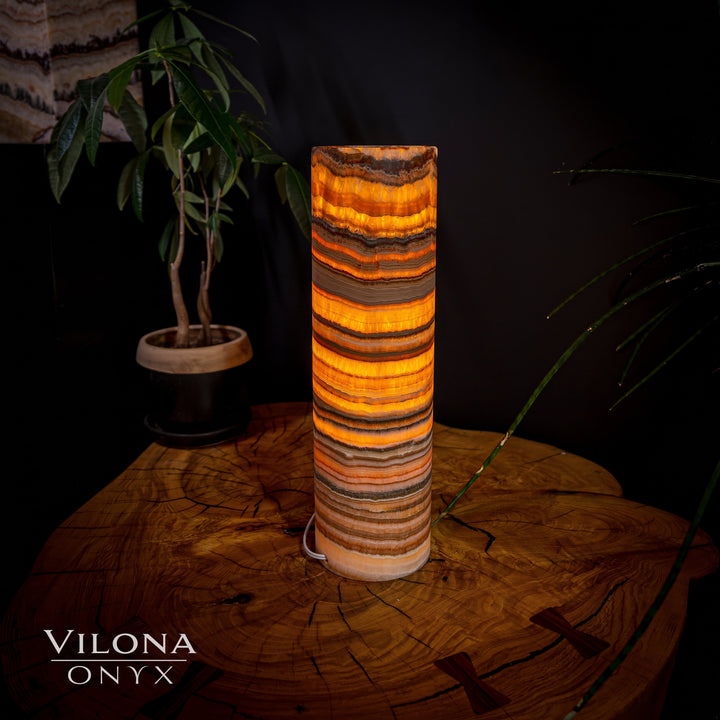 Cylindrical onyx table lamp with layered amber and tan banded stone cylinder shade