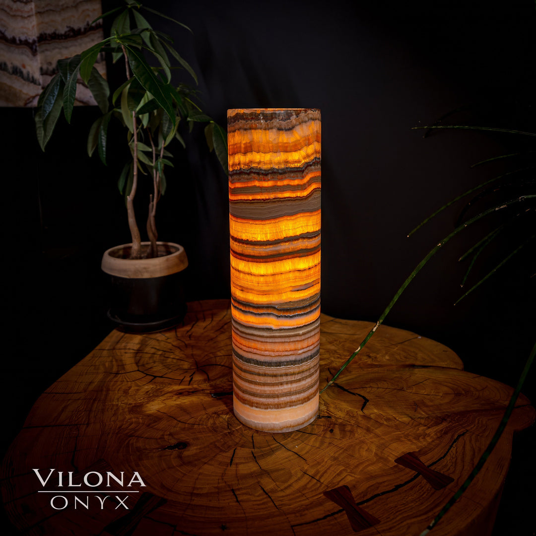 Cylindrical onyx table lamp with bright orange-gold and dark banded stone shade