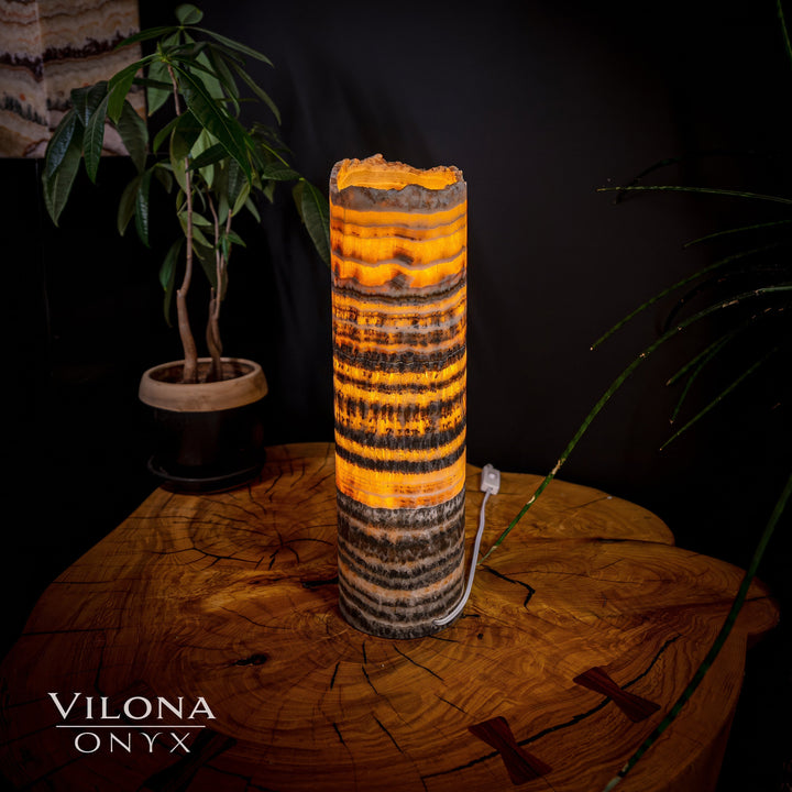 Onyx table lamp with orange banded cylinder shade and rough scalloped top