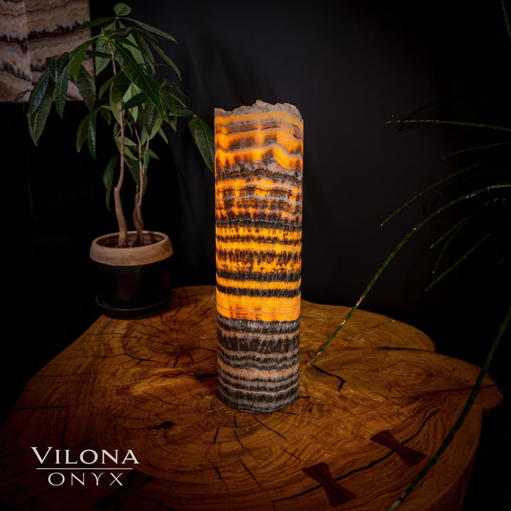 Tall onyx table lamp with orange and black banded cylinder shade and base