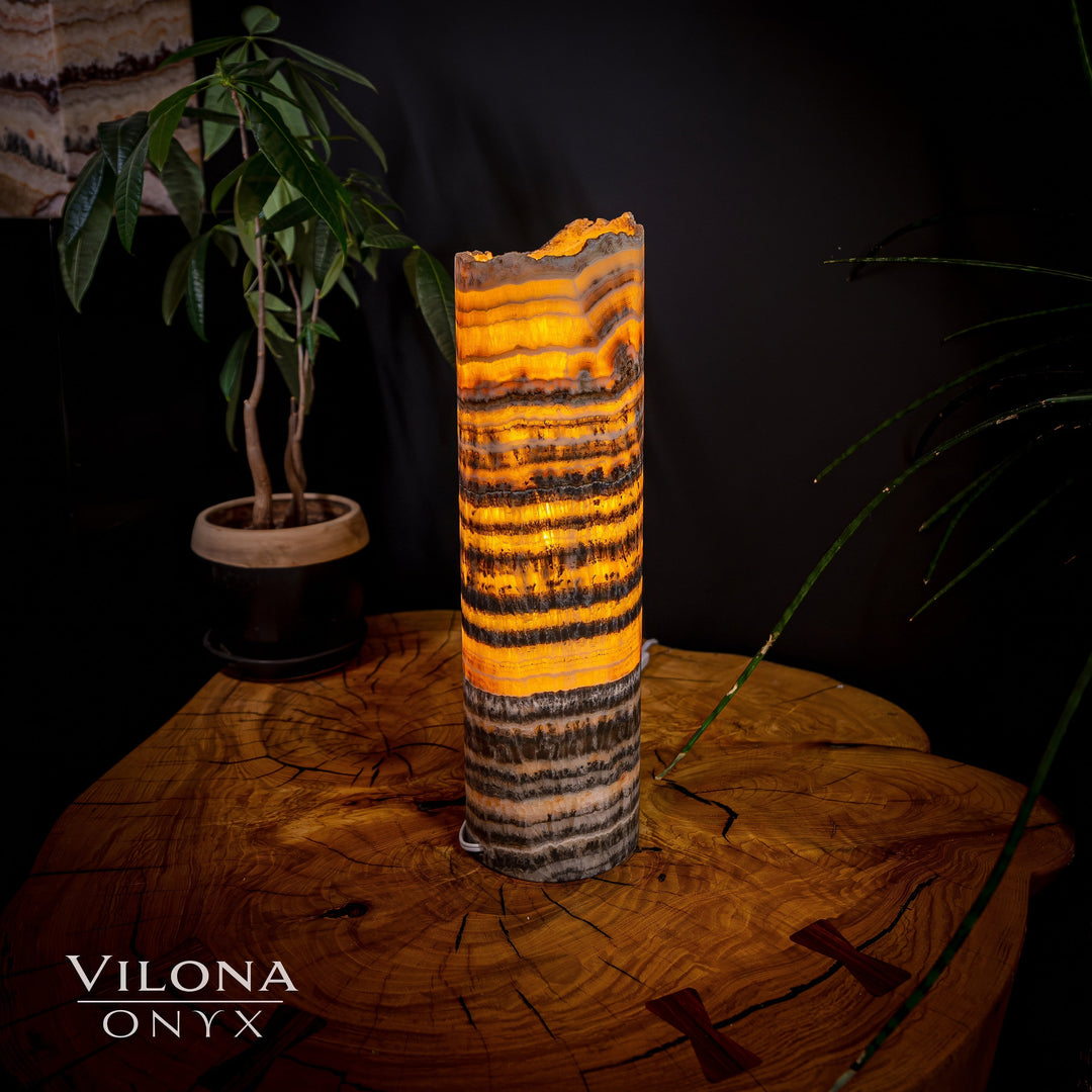 Orange banded onyx table lamp with dark lower banding and rough top edge
