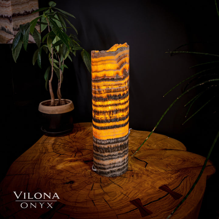 Orange banded onyx table lamp with dark lower banding and rough top edge