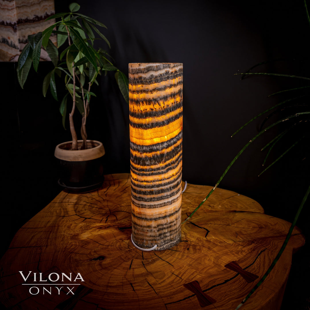 Cylinder onyx table lamp with multicolor amber, tan, and black striping.