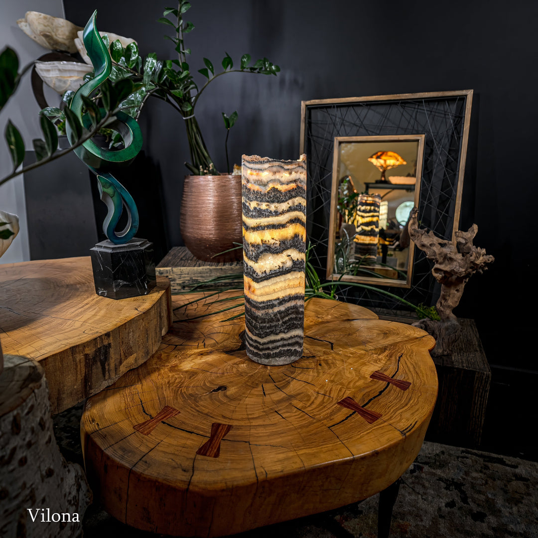 Cylindrical onyx-pattern table lamp with warm glowing core and textured banding