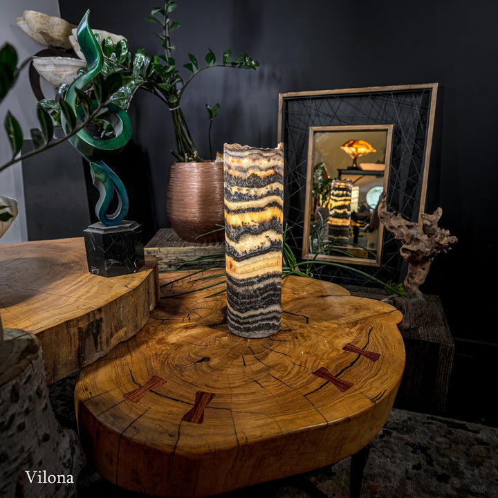Cylindrical onyx-pattern table lamp with warm glowing core and textured banding