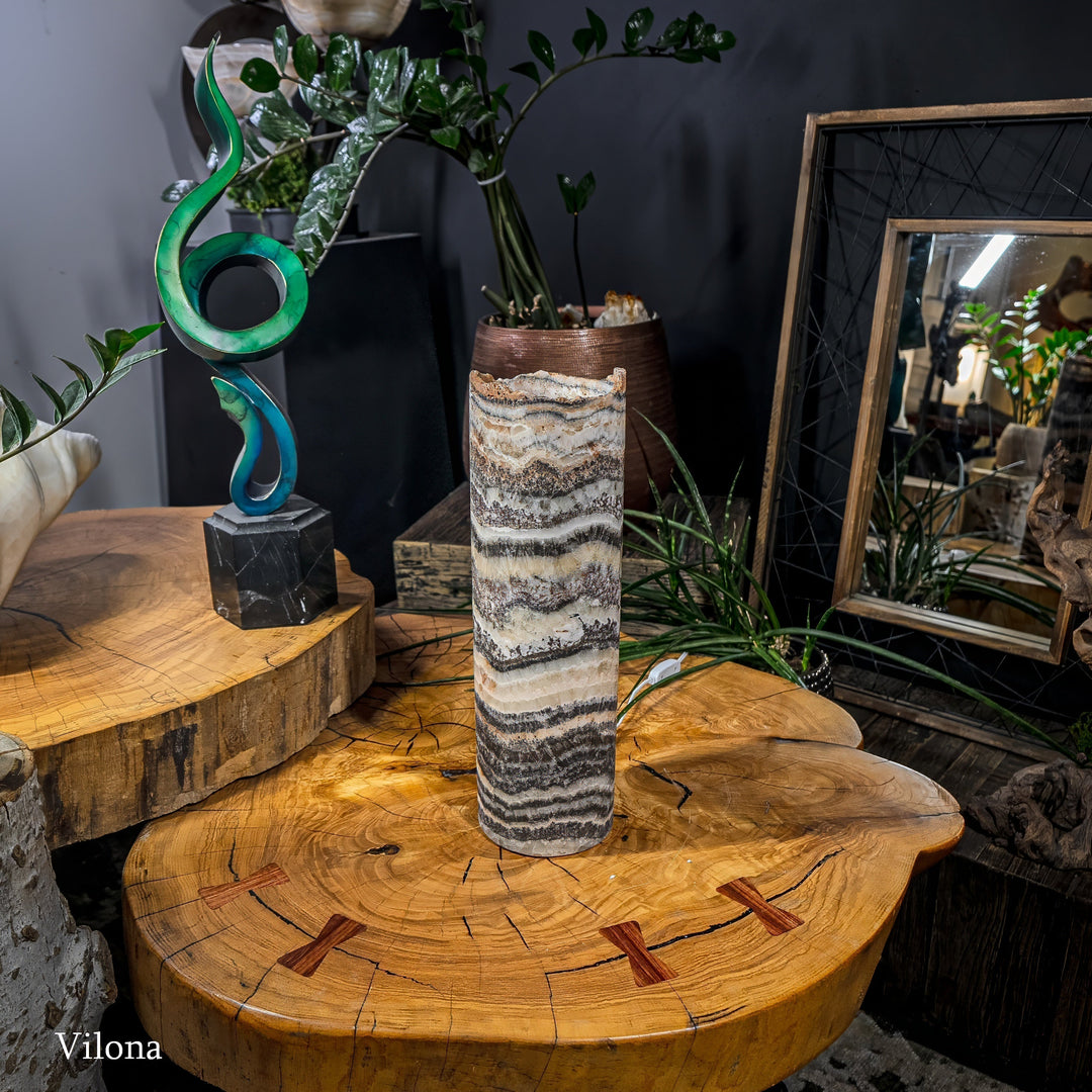 Onyx-pattern table lamp with striped cylinder shade and visible cord