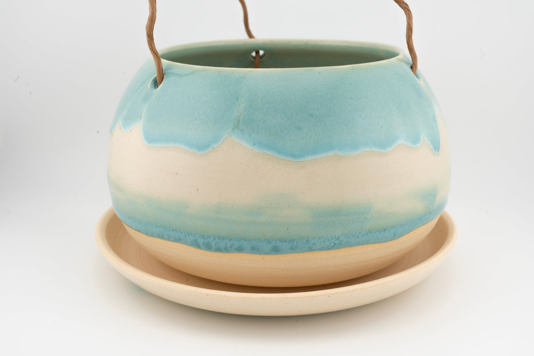 Glazed hanging planter with rope handles and round saucer base, light blue and cream