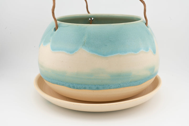 Glazed hanging planter with rope handles and round saucer base, light blue and cream