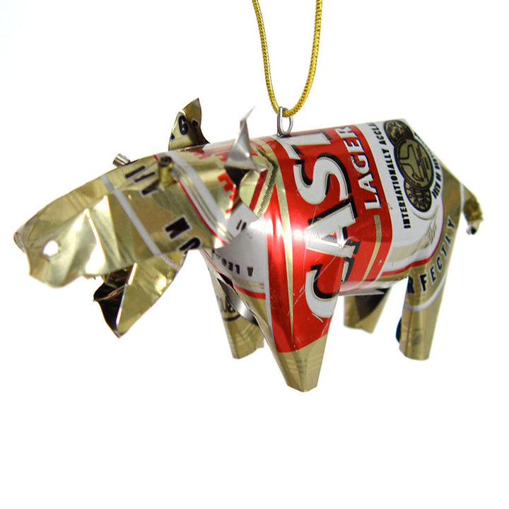 Gold tin hippo ornament with red graphic, hanging on yellow-green cord.