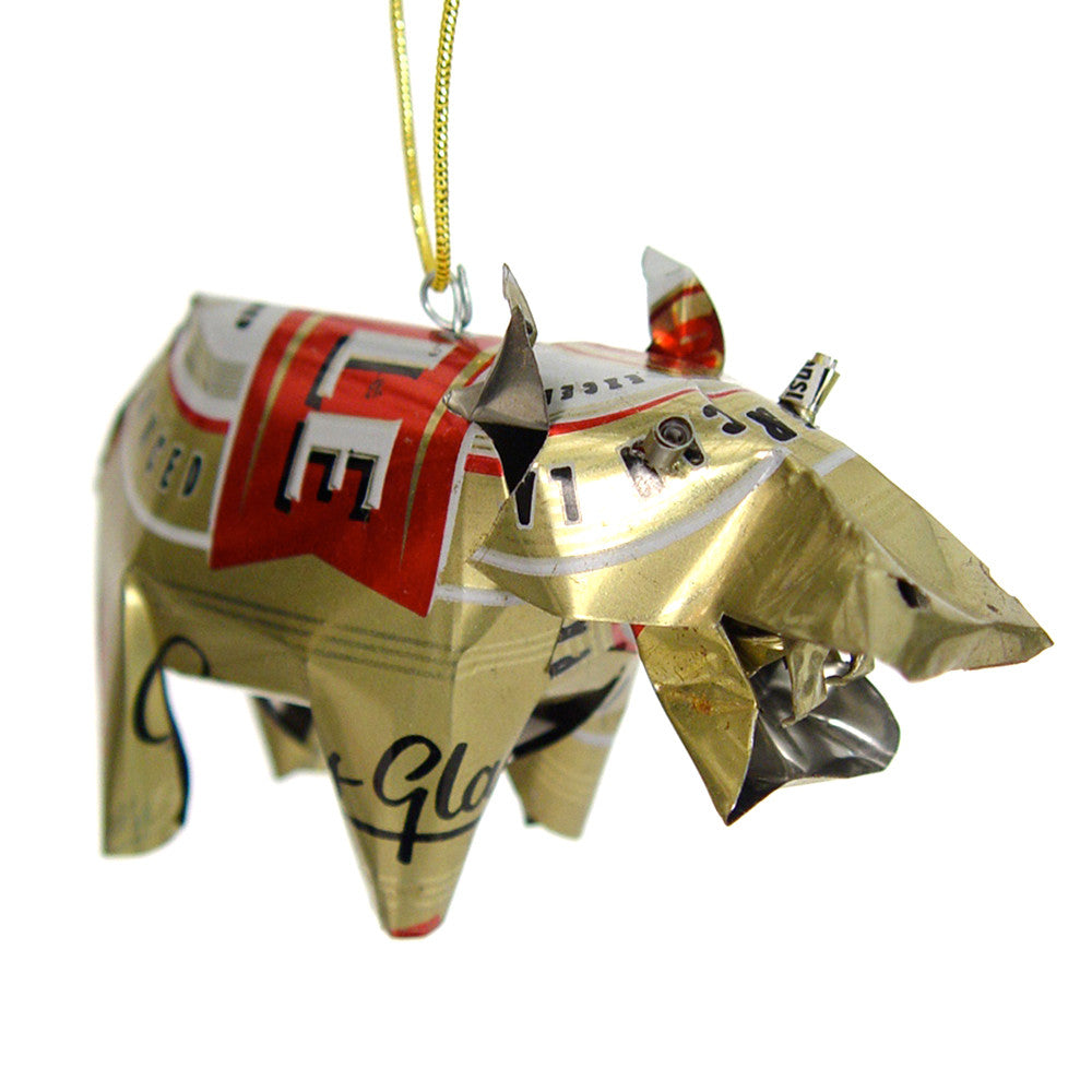 Gold tin hippo ornament with red label print, hanging on yellow-green cord.