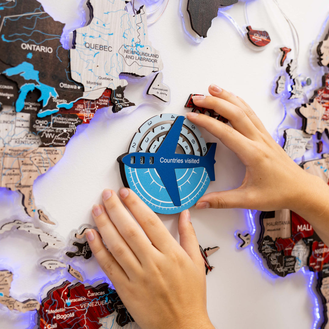 Wooden world map travel tracker with blue compass showing “Countries visited”