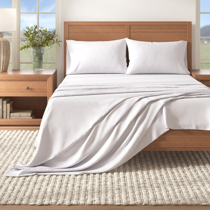 Cotton solid flannel sheet set in winter white with folded drape on bed