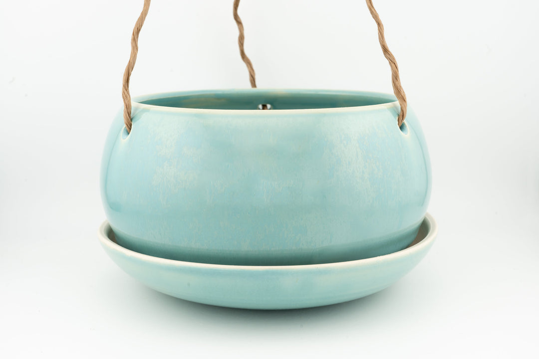 Light blue glazed hanging planter pot with rope handles and drain hole