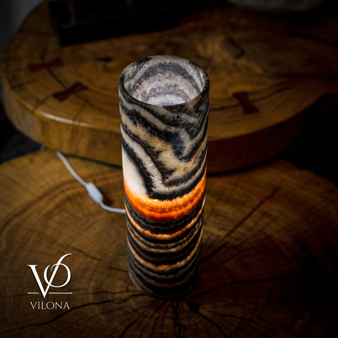 Top and front view of cylindrical onyx-look lamp shade with black and amber wave stripes