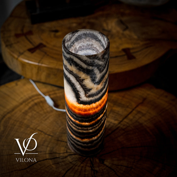 Top and front view of cylindrical onyx-look lamp shade with black and amber wave stripes