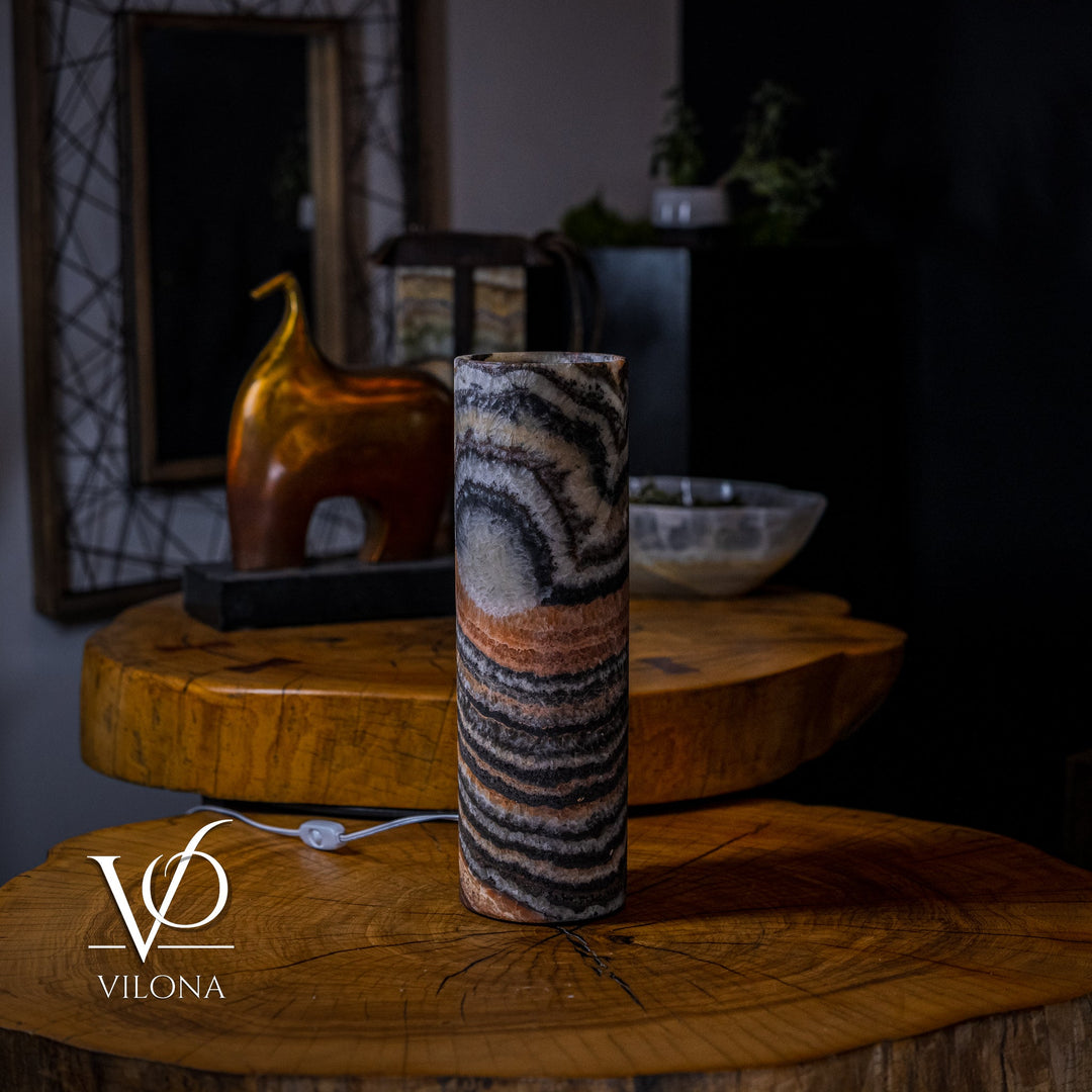 Onyx table lamp with tall cylinder shade featuring dark stripes and amber highlights