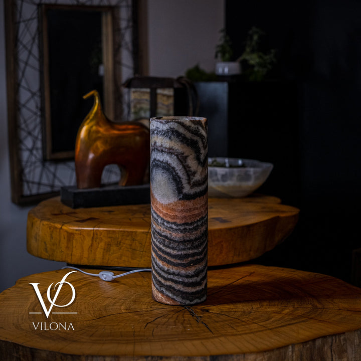 Onyx table lamp with tall cylinder shade featuring dark stripes and amber highlights