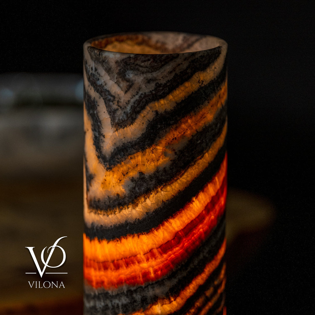 Close view of cylindrical onyx-look lamp shade with black and amber curved bands