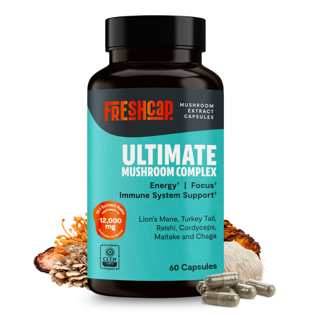Mushroom supplement bottle with black cap, teal label, and included capsules