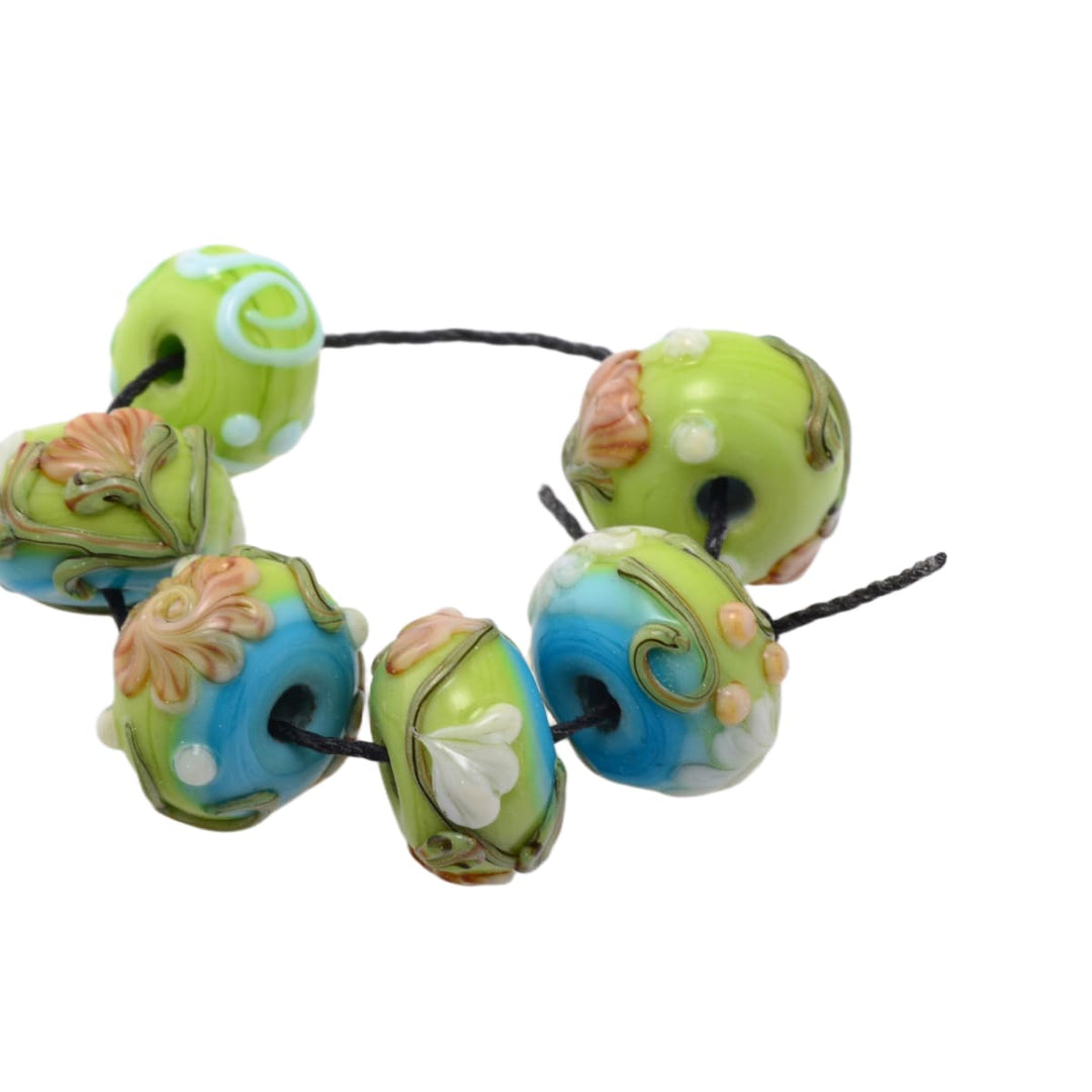 Lampwork glass beads set on black cord, green/blue floral round beads