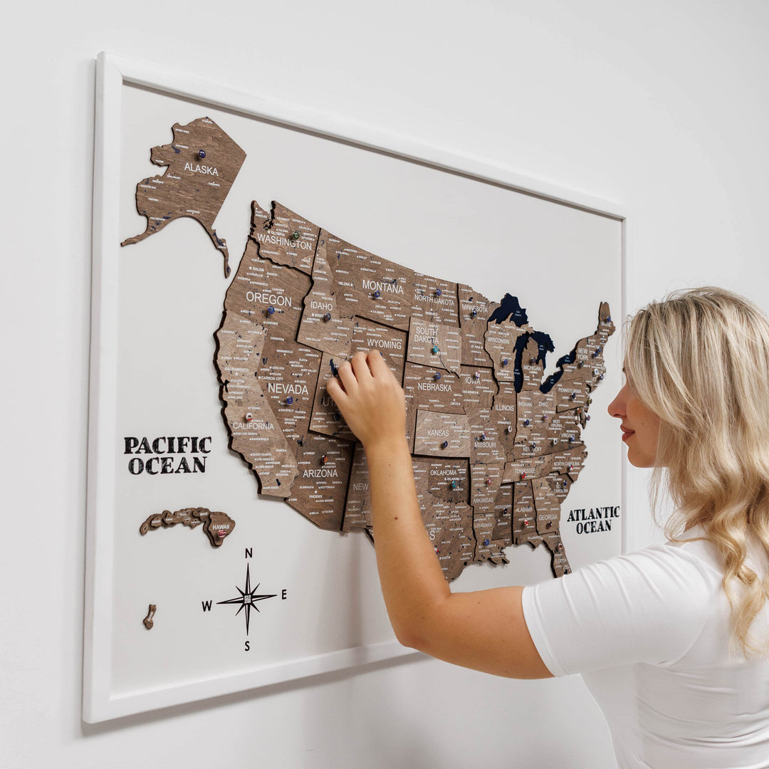 3D wooden USA map wall board with Pacific Ocean label, person touching the map