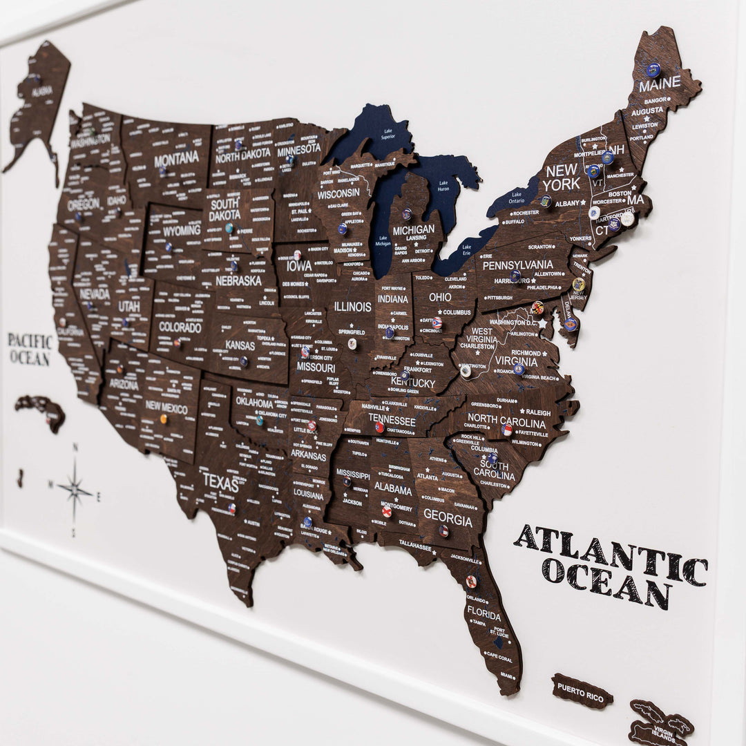 Close-up view of dark walnut 3D USA map with state labels and blue regions