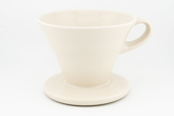 V60 ceramic coffee dripper with drip stand, matte white glaze and side handle.