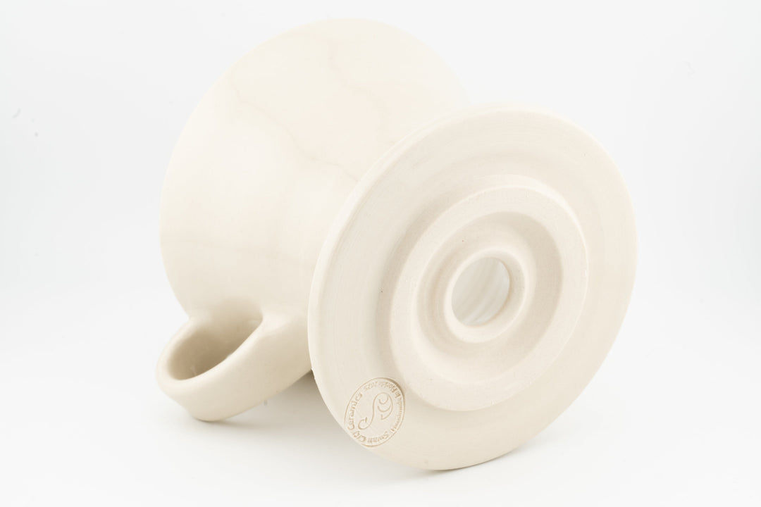 V60 ceramic coffee dripper underside with circular vent, matte white glaze, side handle.